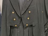 three jackets hanging on a rack in a clothing store