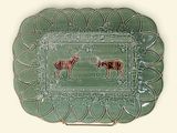 a green plate with a picture of two deers on it