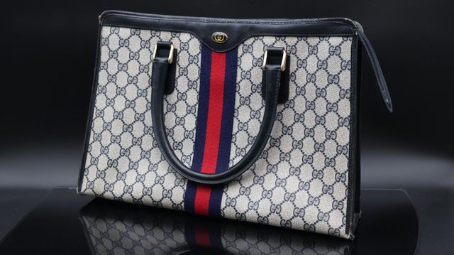 GUCCI – Sac en toile monogrammée et cuir bleu. Coins usés