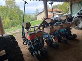 a tractor that is parked next to a row of plow