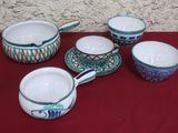 five cups and saucers on a red table cloth