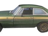 a picture of a green and gold car on a white background