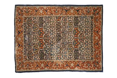 an antique persian rug with a floral design on a blue ground
