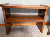 a wooden shelf with a shelf on top of it