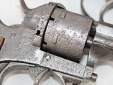 a silver revolver with a wooden handle on a white surface