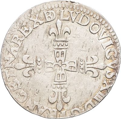 an old silver coin with a cross on it on a white background
