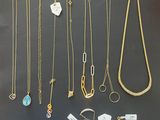 a group of necklaces and bracelets are displayed on a table