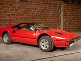 a red sports car parked in front of a brick wall