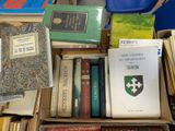 many books in a box on a table