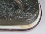 a bronze statue of a horse on a marble base