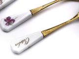 two spoons that have purple flowers on them
