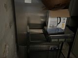 a metal cart with a bowl on top of it in a room