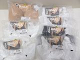 several packages of underwear are wrapped in plastic bags on a counter