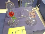 three glass vases with flowers in them sitting on a table