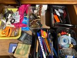 a drawer full of school supplies on the floor