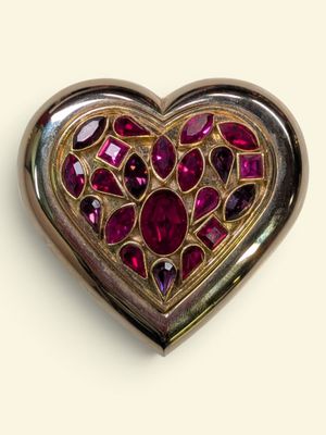 an image of a heart shaped brooch with a lot of red stones