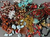 a pile of assorted necklaces and bracelets on a table