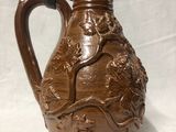 an image of a brown pitcher sitting on top of a white table