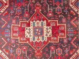 a red and blue rug with an ornate design on it