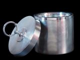 a metal container with a lid on a black background