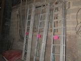several ladders leaning against a wall in a building