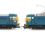 two blue trains sitting side by side on a white surface