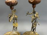 pair of antique brass candlesticks with figurines of a man and a woman
