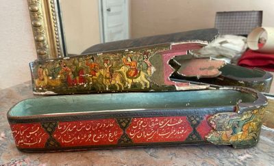 two old suitcases sitting on a table with a mirror in the background