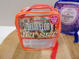 a plastic lunch bag sitting on a table next to a plastic lunch bag