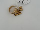 une bague en or portant un numéro, posée sur une table