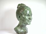 sculpture of a woman ' s head with a bun on her head