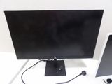 two computer monitors sitting on a white table
