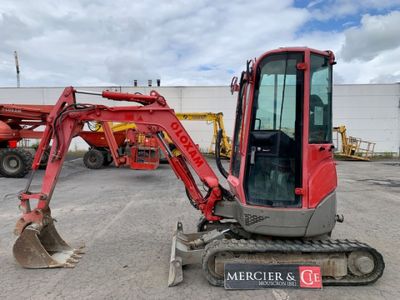 an image of a red excavator parked in a parking lot