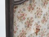 a bed that has a floral headboard on it
