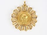 a close up of a gold medal on a white surface