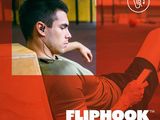 the man is sitting on the floor listening to music on his phone