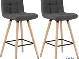 pair of grey fabric bar stools with wooden legs