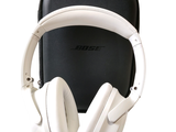a pair of white headphones sitting on top of a black case