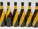 six bouteilles de vin sont alignées sur une table