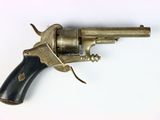 a small revolver with a wooden handle on a white surface