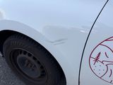 a white car with a sticker on the side of it