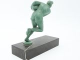 statue of a man holding a baseball bat on a marble base