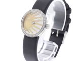 an image of a woman ' s wrist watch with a sun dial and black leather band