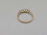 a close up of a gold ring with three diamonds on it