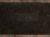 a black area rug on a wooden floor