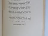 an open book on a white table with a black and white picture