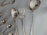 a lot of silver spoons and spoon spoons on the table