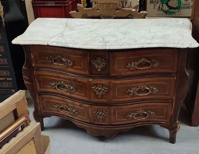 a marble top chest of drawers in a store