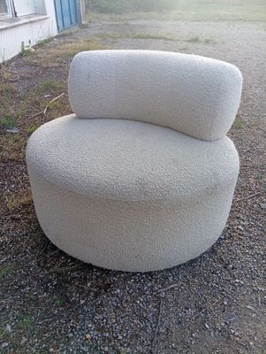 a white chair that is sitting in the dirt