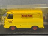 yellow model of a food truck in a clear plastic box